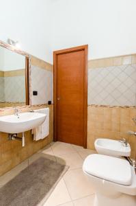 a bathroom with a toilet and a sink at Azzurromare Casa Vacanze in Teulada
