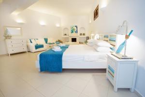 A bed or beds in a room at Thea Villas and Suite