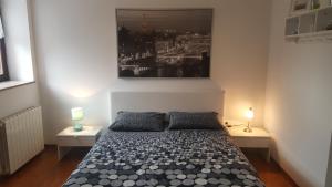 a bedroom with a bed with two lamps and a picture on the wall at Apartments Sorgo in Novigrad Istria +40 photos