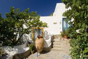 a white building with a tree in front of it at Hotel Girasole in Panarea