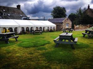a group of picnic tables in a field with a tent at Micro Barn Mickleton Barnard Castle in Mickleton +8 photos