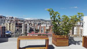 a balcony with two potted plants and a view of a city at Departamento de Lujo La Carolina - Quicentro Shopping in Quito