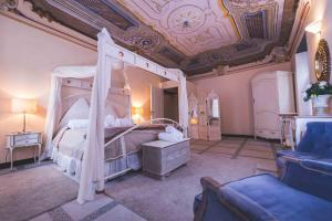 a bedroom with a canopy bed with a coffered ceiling at Il Sogno Maison de Charme in Chiavari