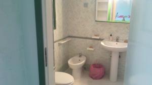 a bathroom with a toilet and a sink at La Casa Dei Delfini in Lampedusa