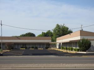 an empty parking lot in front of a building at Mayo Inn in Roswell