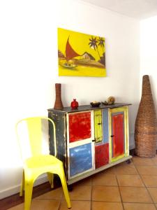 a yellow chair and a dresser in a room at Beach House in Madalena +27 photos