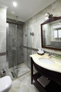 a bathroom with a sink, toilet and bathtub at Divalis Hotel in Istanbul