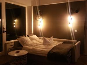 a bedroom with a bed with lights on the wall at Apartment am Zoo in Krefeld