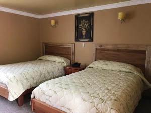 Postel nebo postele na pokoji v ubytování Hotel y Hosteria Natabuela