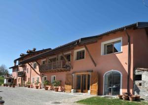 a large house with a balcony on the side of it at Antico fienile in Belluno