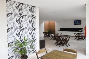 a dining room with a table and a piano at Hotel Estrela de Minas in São Gabriel