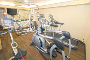 a gym with several cardio machines in a room at Masterpiece Hotel in Morro Bay