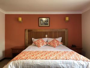 Postel nebo postele na pokoji v ubytování Hotel y Hosteria Natabuela