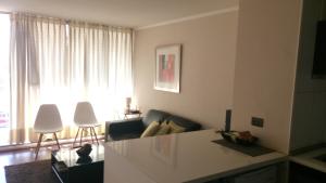a living room with a couch and a table at José Miguel Carrera Depto in Santiago