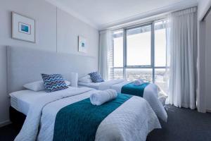 a bedroom with two beds and a large window at Apartment with Ocean Views in Gold Coast