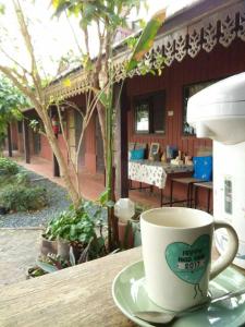 a cup of coffee sitting on a table at Rim Than View Resort in Ubon Ratchathani