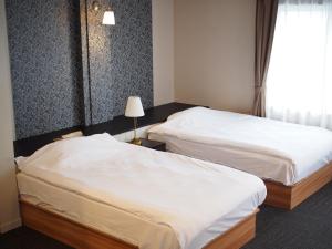 Postel nebo postele na pokoji v ubytování Stay Inn Will URAWA