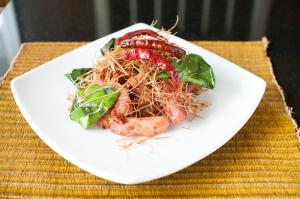 a white plate of food on a table at Kasemsarn Hotel Chanthaburi in Chanthaburi