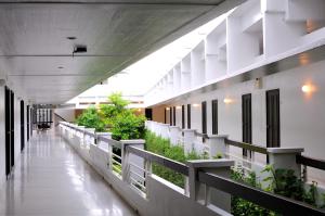 an empty hallway of an office building with plants at Kasemsarn Hotel Chanthaburi in Chanthaburi
