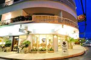 a building with potted plants in front of it at Kasemsarn Hotel Chanthaburi in Chanthaburi