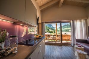a kitchen with a view of a mountain at Monti Pallidi B&B Apartments in Corvara in Badia