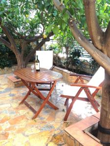 a picnic table and bench under a tree at Magnolia Residence in Mytilene