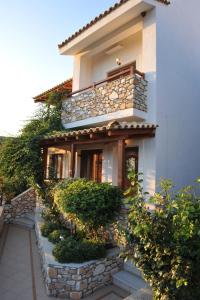 a house with a stone staircase leading up to it at Villa Maraki in Agia Paraskevi