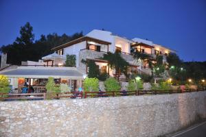a building on top of a stone wall at Villa Maraki in Agia Paraskevi