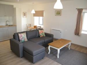 a living room with a couch and a table at Clos Vieux Rochers Vineyard in Puisseguin