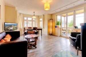 a living room with a couch and a table at Haus Hohlfeld in Bad Schandau