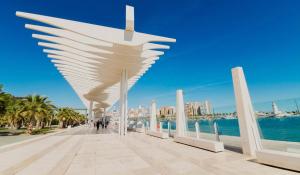 a view of the beach with a white cross on a boardwalk at Apartamento Chay in Málaga