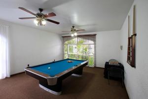 a room with a pool table and a ceiling fan at Villa Bejar Cuernavaca in Cuernavaca
