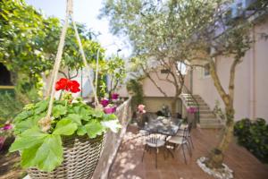 a hanging basket with a red flower on a patio at Villa Milton Hvar in Hvar