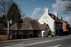 a white building on the side of a street at Cromwell Arms Country Pub with Rooms in Romsey