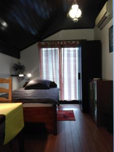 a bedroom with a bed and a large window at Rooms Hazler in Slunj
