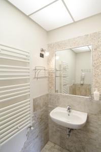 a bathroom with a sink and a mirror at Al Giardino del Vicolo in Ravenna