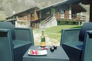 a bottle of champagne on a table with a plate of food at Il Maiolandro in Noasca