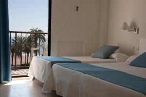 Postel nebo postele na pokoji v ubytování Hotel Sicania