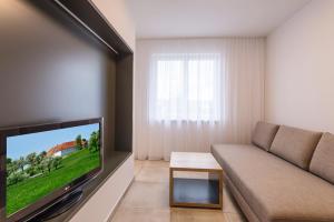 TV a/nebo společenská místnost v ubytování 24/7 Zimmer Asten