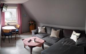 a living room with a couch and a table at Pension-Marion in Bad Zwischenahn