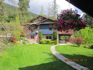 a house with a hanging basket of flowers at Creekside B&B in Nelson