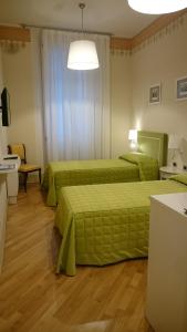 A bed or beds in a room at Casa Isolani Luxury Rooms Piazza Maggiore 1