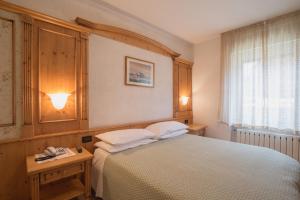 Postel nebo postele na pokoji v ubytování Hotel Centrale