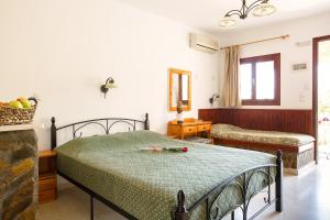 a bedroom with a bed with a green bedspread at Villa Italiana in Agios Nikolaos +64 photos