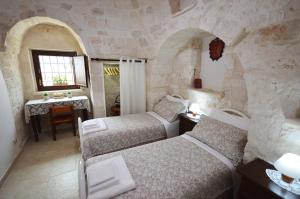 Posteľ alebo postele v izbe v ubytovaní I Trulli Di Nonno Giovanni