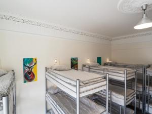 a room with three bunk beds in it at The Hostel in Edinburgh