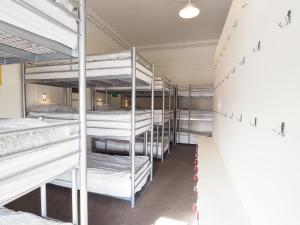 a room with a bunch of bunk beds at The Hostel in Edinburgh