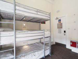 two bunk beds in a room with a hallway at The Hostel in Edinburgh