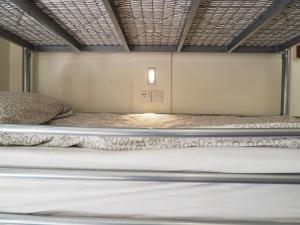 a bed in a small room with a mattress at The Hostel in Edinburgh