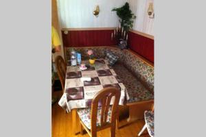 a living room with a couch and a table at Haus Tulpe in Strobl